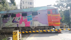 Size: 1280x720 | Tagged: safe, derpibooru import, pinkie pie, rarity, twilight sparkle, twilight sparkle (alicorn), alicorn, earth pony, unicorn, barrier, bilibili source, china, diesel locomotive, female, hasbro logo, irl, locomotive, mare, photo, shenzhen, train, tree