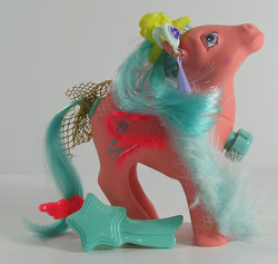 Size: 634x600 | Tagged: safe, derpibooru import, photographer:breyer600, g1, barrette, bow, comb, dance 'n prance pony, ear piercing, earring, feather boa, jewelry, piercing, simple background, songster, tail bow, toy