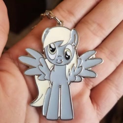Size: 1080x1080 | Tagged: safe, derpibooru import, derpy hooves, human, pegasus, pony, hand, irl, irl human, irl photo, keychain, photo, spread wings, wings