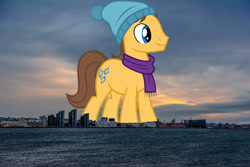 Size: 2000x1333 | Tagged: safe, artist:jaredking779, artist:sofunnyguy, derpibooru import, caramel, earth pony, pony, background pony, clothes, giant pony, giant/macro earth pony, hat, highrise ponies, iceland, irl, macro, male, mega giant, photo, ponies in real life, scarf, smiling, solo, stallion