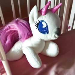 Size: 512x512 | Tagged: safe, derpibooru import, generator:stable diffusion, machine learning generated, bicorn, crib, foal, horn, multiple horns, photo, plushie