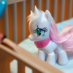 Size: 512x512 | Tagged: safe, derpibooru import, generator:stable diffusion, machine learning generated, crib, foal, photo, plushie