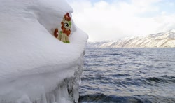 Size: 2048x1201 | Tagged: safe, derpibooru import, photographer:pakapaka1993, autumn blaze, kirin, pony, icicle, irl, japan, mountain, ocean, photo, plushie, snow, solo, water, winter