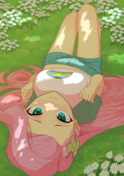 Size: 2480x3508 | Tagged: safe, artist:でかすじ, derpibooru import, fluttershy, equestria girls, blushing, breasts, clothes, cutie mark accessory, eyelashes, female, flower, grass, hairclip, high res, hootershy, long hair, looking at you, lying down, on back, on ground, outdoors, shirt, shorts, smiling, smiling at you, solo, t-shirt