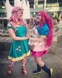 Size: 1080x1350 | Tagged: safe, artist:sweetalissum, derpibooru import, fluttershy, pinkie pie, human, equestria girls, clothes, cosplay, costume, dress, fountain, irl, irl human, photo