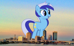 Size: 2000x1260 | Tagged: safe, artist:90sigma, artist:thegiantponyfan, derpibooru import, minuette, pony, unicorn, female, florida, giant pony, giant unicorn, giantess, highrise ponies, irl, jacksonville, macro, mare, mega giant, mega/giant minuette, multicolored mane, multicolored tail, open mouth, open smile, photo, ponies in real life, smiling, tail