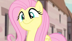 Size: 1258x720 | Tagged: safe, derpibooru import, screencap, fluttershy, pegasus, pony, season 5, the cutie map, :t, blurry background, cute, female, flutterbob, happy, in our town, mare, outdoors, party soft, shyabetes, smiling, solo