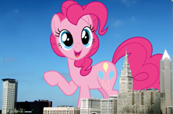 Size: 1347x884 | Tagged: safe, artist:dashiesparkle, artist:thegiantponyfan, derpibooru import, pinkie pie, earth pony, pony, cleveland, female, giant pinkie pie, giant pony, giant/macro earth pony, giantess, highrise ponies, irl, looking at you, macro, mare, mega giant, ohio, open mouth, open smile, photo, ponies in real life, raised hoof, raised leg, smiling