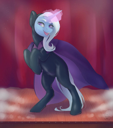 Size: 1024x1159 | Tagged: safe, artist:nekotoko, edit, editor:anonymous, ponerpics import, trixie, pony, unicorn, bipedal, bondage, cape, clothes, ear fluff, ears, encasement, female, glowing horn, hooves to the chest, horn, latex, latex suit, magic, mare, open mouth, rearing, smiling, solo, stage, trixie's cape