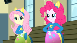 Size: 3410x1920 | Tagged: safe, derpibooru import, screencap, fluttershy, pinkie pie, eqg summertime shorts, equestria girls, steps of pep, clothes, cutie mark on clothes, duo, duo female, female, hand on hip, high res, looking at each other, looking at someone, smiling, smiling at each other, wondercolts uniform