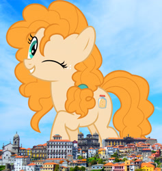 Size: 2658x2808 | Tagged: safe, artist:jhayarr23, artist:thegiantponyfan, derpibooru import, pear butter, earth pony, pony, female, giant pony, giant/macro earth pony, giantess, grin, high res, highrise ponies, irl, looking at you, macro, mare, mega giant, one eye closed, photo, ponies in real life, portugal, smiling, solo, wink