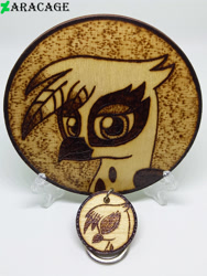 Size: 3000x4000 | Tagged: safe, artist:aracage, derpibooru import, gilda, griffon, bust, coaster, eyes closed, irl, keychain, looking at you, photo, portrait, profile, pyrography, traditional art