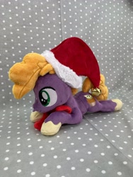 Size: 3024x4032 | Tagged: safe, artist:kazzysart, derpibooru import, little mac, pony, christmas, hat, holiday, irl, lying down, photo, plushie, prone, santa hat, solo