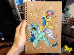 Size: 4096x3072 | Tagged: safe, artist:julunis14, derpibooru import, bon bon, lyra heartstrings, sweetie drops, earth pony, pony, unicorn, hand, irl, music notes, notebook, photo, traditional art