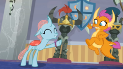 Size: 1600x898 | Tagged: safe, derpibooru import, screencap, ocellus, smolder, changedling, changeling, dragon, a matter of principals, cute, diaocelles, dragoness, eyes closed, female, helm of yickslur, helmet, raised hoof, raised leg, smolderbetes