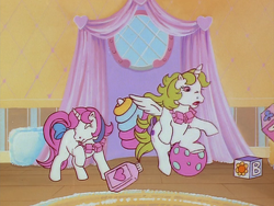 Size: 960x720 | Tagged: safe, derpibooru import, screencap, baby moondancer, baby surprise, alicorn, pony, unicorn, escape from catrina, g1, my little pony 'n friends, animation error, baby, baby pony, ball, blocks, bow, duo, female, filly, flying, foal, jewelry, necklace, nursery, princess surprise, spot the alicorn, spread wings, tail, tail bow, wings