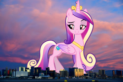 Size: 1524x1016 | Tagged: safe, artist:rustle-rose, derpibooru import, edit, editor:jaredking779, princess cadance, alicorn, pony, attack on pony, colored wings, crown, eyebrows, female, folded wings, giant pony, giantess, highrise ponies, hoof shoes, irl, jewelry, las vegas, lidded eyes, looking at you, macro, mare, multicolored hair, multicolored tail, multicolored wings, nevada, peytral, photo, ponies in real life, raised eyebrow, raised leg, red eyes, regalia, smiling, smirk, solo, tail, wings