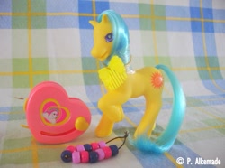 Size: 761x565 | Tagged: safe, derpibooru import, earth pony, pony, g2, bead machine, beads, comb, female, irl, mare, photo, raised hoof, raised leg, smiling, solo, springly, tail, toy, unshorn fetlocks