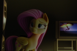 Size: 768x512 | Tagged: safe, derpibooru import, machine learning generated, fluttershy, pegasus, pony, 3d, 3d model, black eye, blurry background, cutie mark, eyes open, fake, movie, pink hair, pink mane, realistic, room, sad, solo, television, vhs, witch