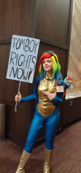 Size: 1956x4128 | Tagged: safe, derpibooru import, rainbow dash, human, bodysuit, boots, clothes, cosplay, costume, epic, form fitting, goggles, goggles on head, irl, irl human, photo, plushie, pointing, shoes, sign, solo, tomboy, uniform, wig, wonderbolts uniform