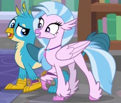 Size: 1855x1580 | Tagged: safe, derpibooru import, screencap, gallus, silverstream, griffon, hippogriff, a matter of principals, bookshelf, cropped, duo, duo male and female, excited, female, happy, male, rug, school, smug