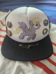 Size: 960x1280 | Tagged: safe, derpibooru import, derpy hooves, buttons, cap, death metal, hat, merchandise, safety pin