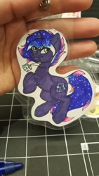 Size: 1152x2048 | Tagged: safe, artist:inkkeystudios, derpibooru import, oc, oc only, pony, unicorn, badge, ethereal mane, eye clipping through hair, galaxy mane, jewelry, looking at you, necklace, pendant, photo, smiling, solo, traditional art