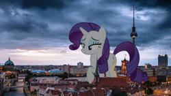 Size: 900x506 | Tagged: safe, artist:chapto, derpibooru import, rarity, pony, unicorn, berlin, female, giant ponies in real life, giant pony, giantess, highrise ponies, irl, looking down, macro, macro/micro, mare, micro, photo, ponies in real life, raised hoof, raised leg, smiling, walking