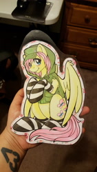 Size: 2988x5312 | Tagged: safe, artist:inkkeystudios, derpibooru import, fluttershy, pegasus, pony, alternate hairstyle, badge, cap, clothes, hat, hoodie, jacket, looking at you, paper pony, photo, sitting, socks, solo, spread wings, striped socks, traditional art, wings