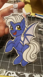 Size: 2988x5312 | Tagged: safe, artist:inkkeystudios, derpibooru import, oc, oc only, bat pony, pony, badge, fangs, looking at you, open mouth, open smile, photo, smiling, solo, spread wings, traditional art, wings
