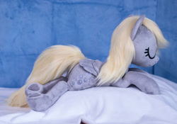 Size: 1415x990 | Tagged: safe, artist:buttercupbabyppg, derpibooru import, derpy hooves, pegasus, pony, eyes closed, female, folded wings, happy, irl, lying down, mare, photo, plushie, prone, sleeping, wings