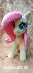 Size: 1890x4096 | Tagged: safe, artist:doctorkoda, derpibooru import, fluttershy, pegasus, pony, female, folded wings, irl, mare, photo, plushie, smiling, solo, standing, wings