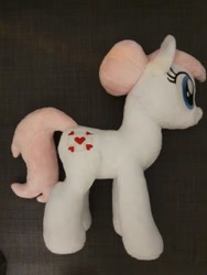 Size: 240x320 | Tagged: safe, artist:melodisde, derpibooru import, nurse redheart, earth pony, pony, bun, female, happy, irl, mare, photo, plushie, smiling, solo, standing