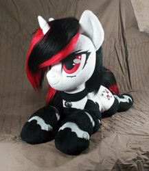 Size: 2946x3394 | Tagged: safe, artist:doctorkoda, derpibooru import, oc, oc only, oc:blackjack, unicorn, fallout equestria, fallout equestria: project horizons, bell, colalr, female, horn, irl, lying down, photo, plushie, prone, solo