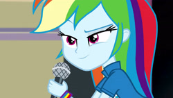 Size: 3072x1727 | Tagged: safe, derpibooru import, screencap, rainbow dash, human, equestria girls, friendship games, chs rally song, clothes, cutie mark on clothes, eyebrows, female, microphone, raised eyebrow, smiling, solo