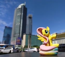 Size: 3453x3000 | Tagged: safe, derpibooru import, fluttershy, pegasus, pony, blurry background, city, cityscape, figure, food, high res, indonesia, irl, jakarta, macaron, photo, pop mart, skyscraper, solo