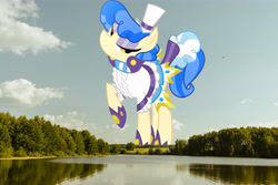 Size: 6000x4000 | Tagged: safe, artist:dashiesparkle, derpibooru import, edit, editor:jaredking779, sapphire shores, earth pony, pony, absurd resolution, clothes, female, giant pony, giantess, hat, highrise ponies, irl, lake, looking at you, macro, mare, photo, ponies in real life, raised hoof, raised leg, scenery, smiling, solo, tree, water