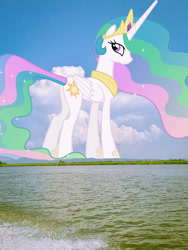 Size: 1440x1920 | Tagged: safe, artist:90sigma, derpibooru import, edit, editor:jaredking779, princess celestia, alicorn, pony, crown, female, folded wings, giant pony, giantess, giantlestia, highrise ponies, hoof shoes, irl, jewelry, looking at you, looking back, looking back at you, macro, mare, mountain, mountain range, peytral, photo, ponies in real life, regalia, scenery, smiling, solo, water, wings