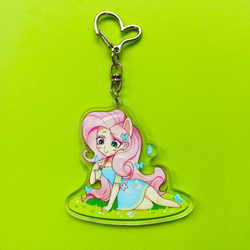Size: 3389x3389 | Tagged: safe, artist:ikstina, derpibooru import, fluttershy, butterfly, human, equestria girls, acrylic plastic, blushing, chibi, clothes, cute, dress, ears, fluttershy boho dress, for sale, grass, grass field, green background, green eyes, irl, keychain, long hair, looking down, makeup, merchandise, on grass, photo, pink hair, pony ears, sale, simple background, solo, sticker