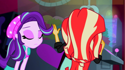 Size: 3072x1727 | Tagged: safe, derpibooru import, screencap, starlight glimmer, sunset shimmer, human, equestria girls, mirror magic, spoiler:eqg specials, beanie, canterlot mall, cinema, clothes, duo, duo female, eyes closed, female, frown, hat, jacket, leather, leather jacket