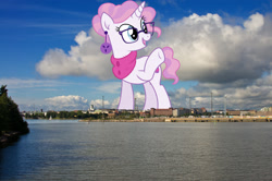 Size: 1600x1065 | Tagged: safe, artist:cirillaq, derpibooru import, edit, editor:jaredking779, raspberry latte, pony, unicorn, clothes, ear piercing, earring, female, finland, giant pony, giantess, glasses, helsinki, highrise ponies, irl, jewelry, macro, mare, photo, piercing, ponies in real life, raised hoof, raised leg, scarf, solo, story included