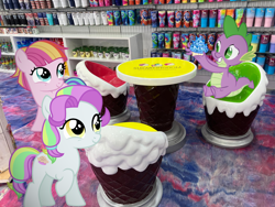 Size: 1280x960 | Tagged: safe, editor:undeadponysoldier, photographer:undeadponysoldier, coconut cream, spike, toola roola, dragon, earth pony, pony, best friends, candy store, chair, cup, cupcake, cute, dragons in real life, female, filly, foal, hanging out, happy, male, ponies in real life, sapphire cupcake, shelf, shop, sitting, table