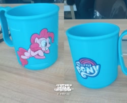 Size: 601x489 | Tagged: safe, artist:alicorn-stevonnie, derpibooru exclusive, derpibooru import, pinkie pie, earth pony, pony, g4, cup, female, irl, mare, merchandise, my little pony logo, photo, smiling, solo, table, text, workplace