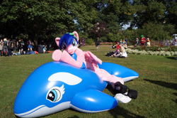 Size: 640x426 | Tagged: safe, artist:atalonthedeer, derpibooru import, firefly, human, whale, g1, 2012, connichi, fursuit, grass, grass field, inflatable, irl, irl human, lying down, outdoors, photo, ponysuit, prone, solo focus