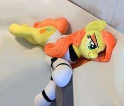 Size: 1733x1490 | Tagged: safe, artist:madi, derpibooru import, oc, oc only, oc:anna pine, earth pony, pony, clothes, freckles, green eyes, lying down, orange mane, orange tail, photo, plushie, smug, suit, tail, yellow mane