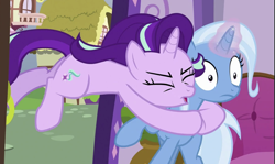 Size: 893x531 | Tagged: safe, derpibooru import, screencap, starlight glimmer, trixie, pony, unicorn, all bottled up, g4, season 7, cropped, duo, glowing, glowing horn, horn, my little pony: friendship is magic, tackle, tackle hug