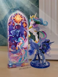 Size: 2126x2834 | Tagged: safe, derpibooru import, princess celestia, princess luna, alicorn, g4, acrylic plastic, acrylic standee, craft, duo, indoors, kotobukiya, kotobukiya princess celestia, kotobukiya princess luna, looking at each other, looking at someone, looking at you, merchandise, official, spread wings, stained glass, stars, sun, wings