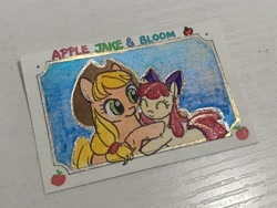 Size: 4000x3000 | Tagged: safe, artist:foluolunsadedengta, derpibooru import, apple bloom, applejack, earth pony, pony, apple, apple sisters, bow, eyes closed, female, filly, foal, food, hair bow, hat, hug, mare, passepartout, photo, siblings, sisters, sky background, smiling, stamp, text, traditional art