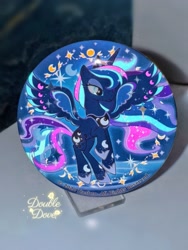 Size: 1752x2336 | Tagged: safe, derpibooru import, princess luna, g4, badge, glow in the dark, irl, merchandise, moon, official, photo, rainbow power, rainbow power-ified, raised hoof, raised leg, spread wings, stars, transparent mane, wings