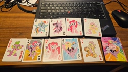 Size: 4000x2252 | Tagged: safe, derpibooru import, applejack, fluttershy, pinkie pie, rainbow dash, rarity, spike, twilight sparkle, twilight sparkle (alicorn), alicorn, dragon, earth pony, pegasus, pony, unicorn, g4, ace of clubs, ace of diamonds, ace of hearts, ace of spades, beer card, female, flying, horn, indoors, jack of spades, joker, king of clubs, mane seven, mane six, mare, merchandise, official, photo, playing card, queen of hearts, stock vector